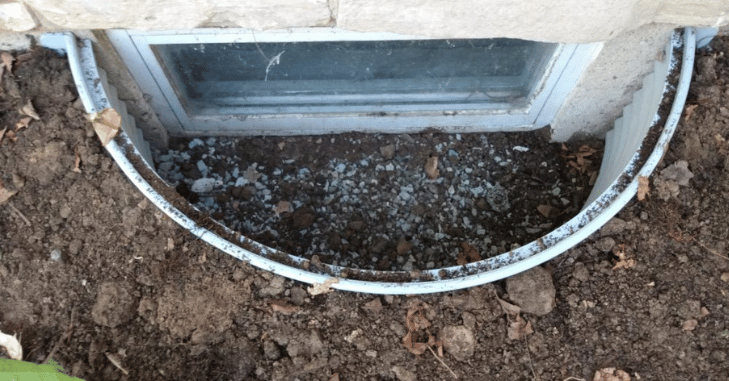 Window well with a ladder beside an egress opening